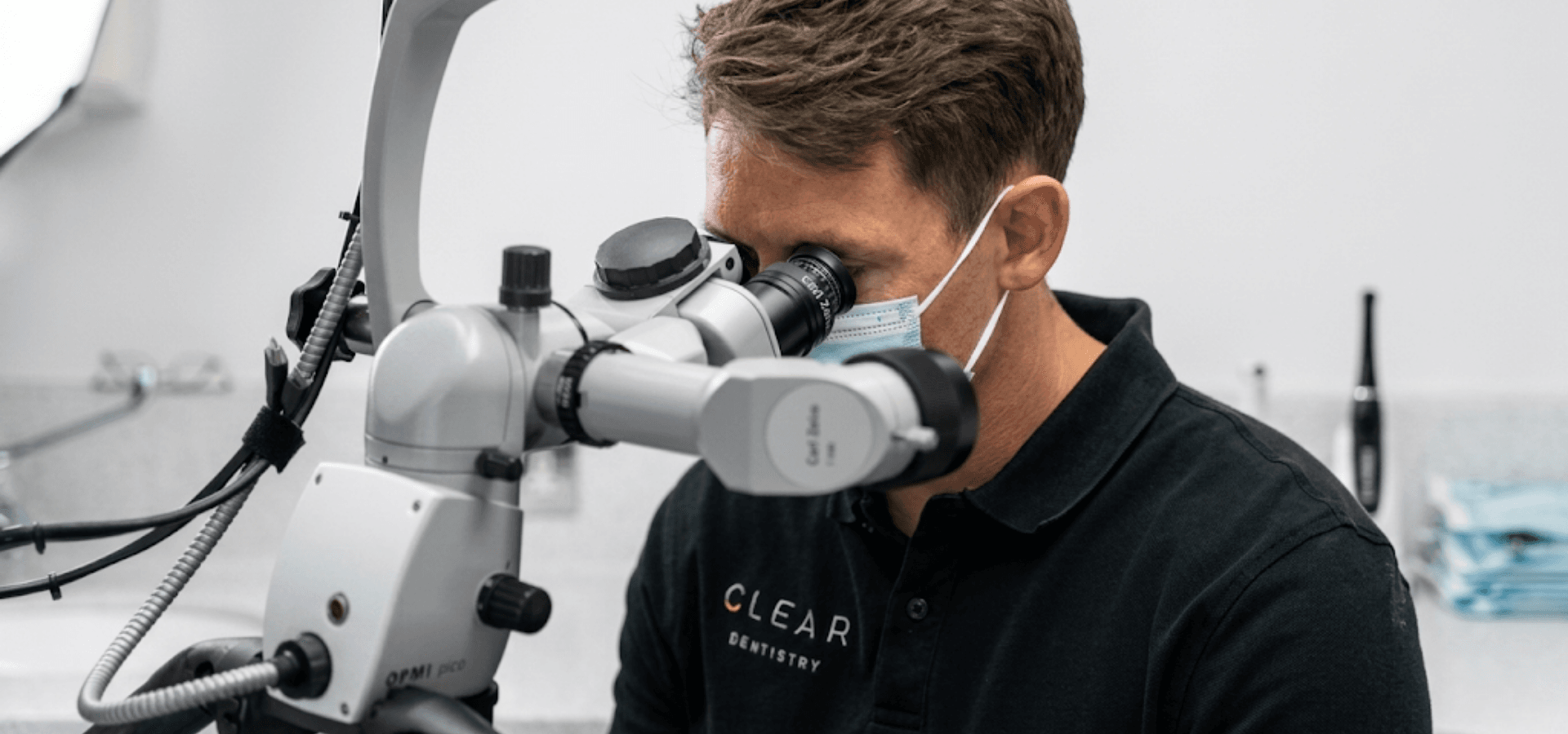 A dentist working through the operating microscope