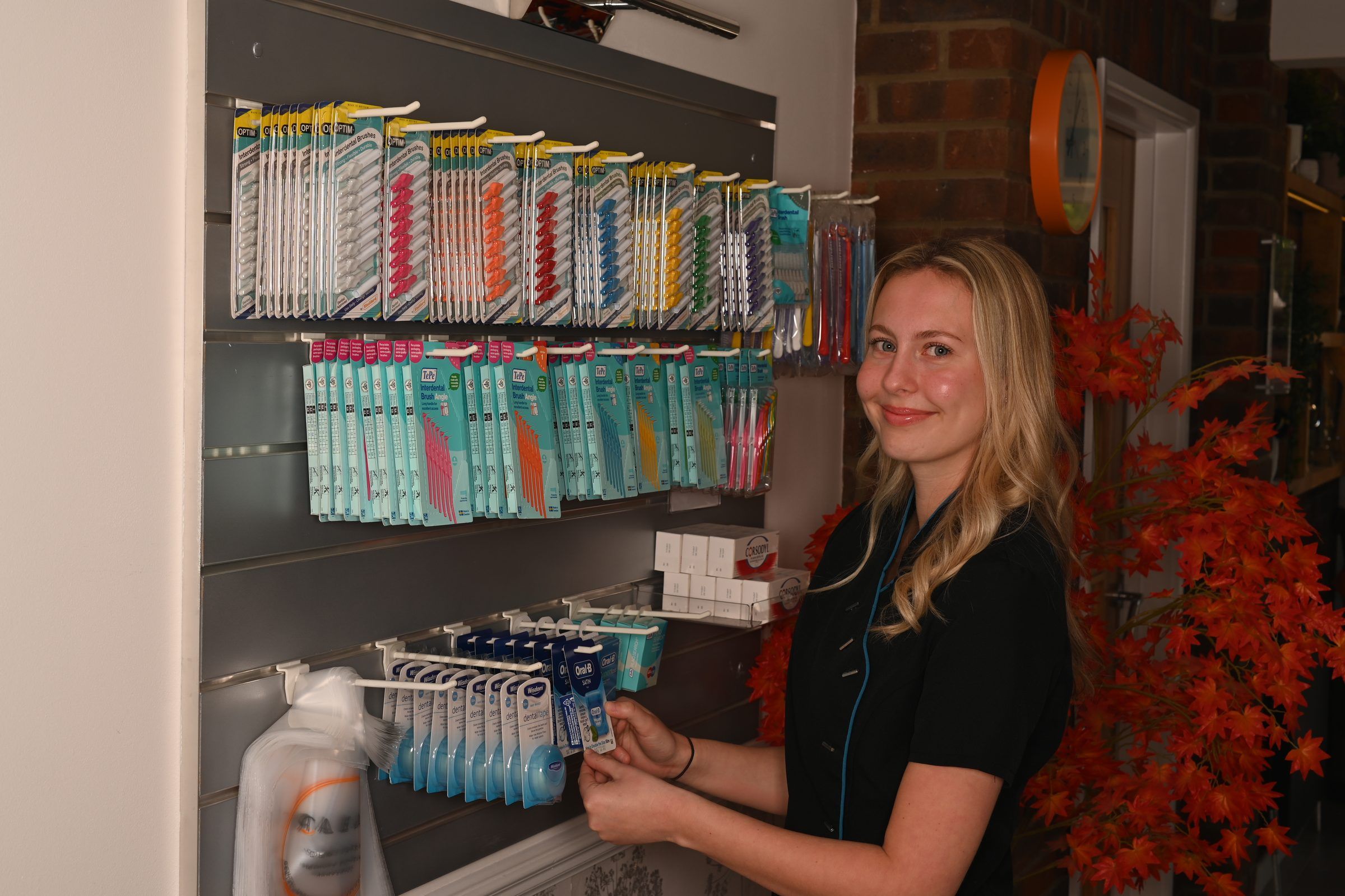 A team member at the practice's range of interdental brushes and hygiene products