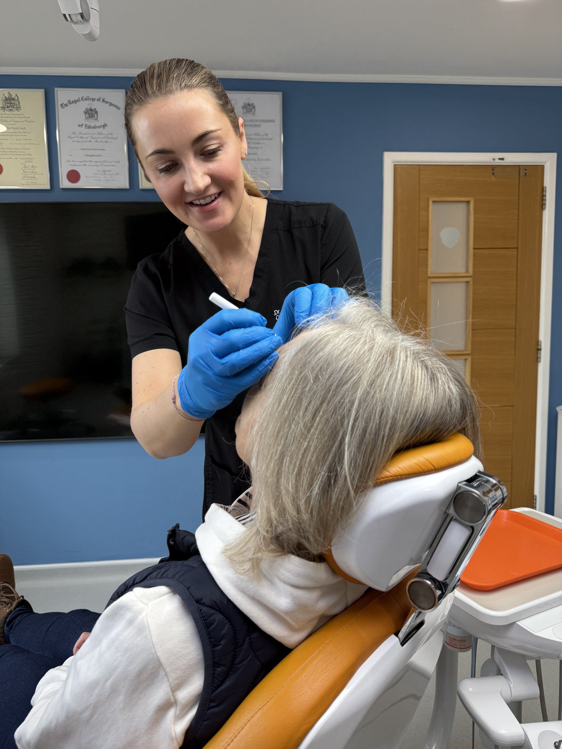 Dr Laura Milligan assessing a patient before treatment