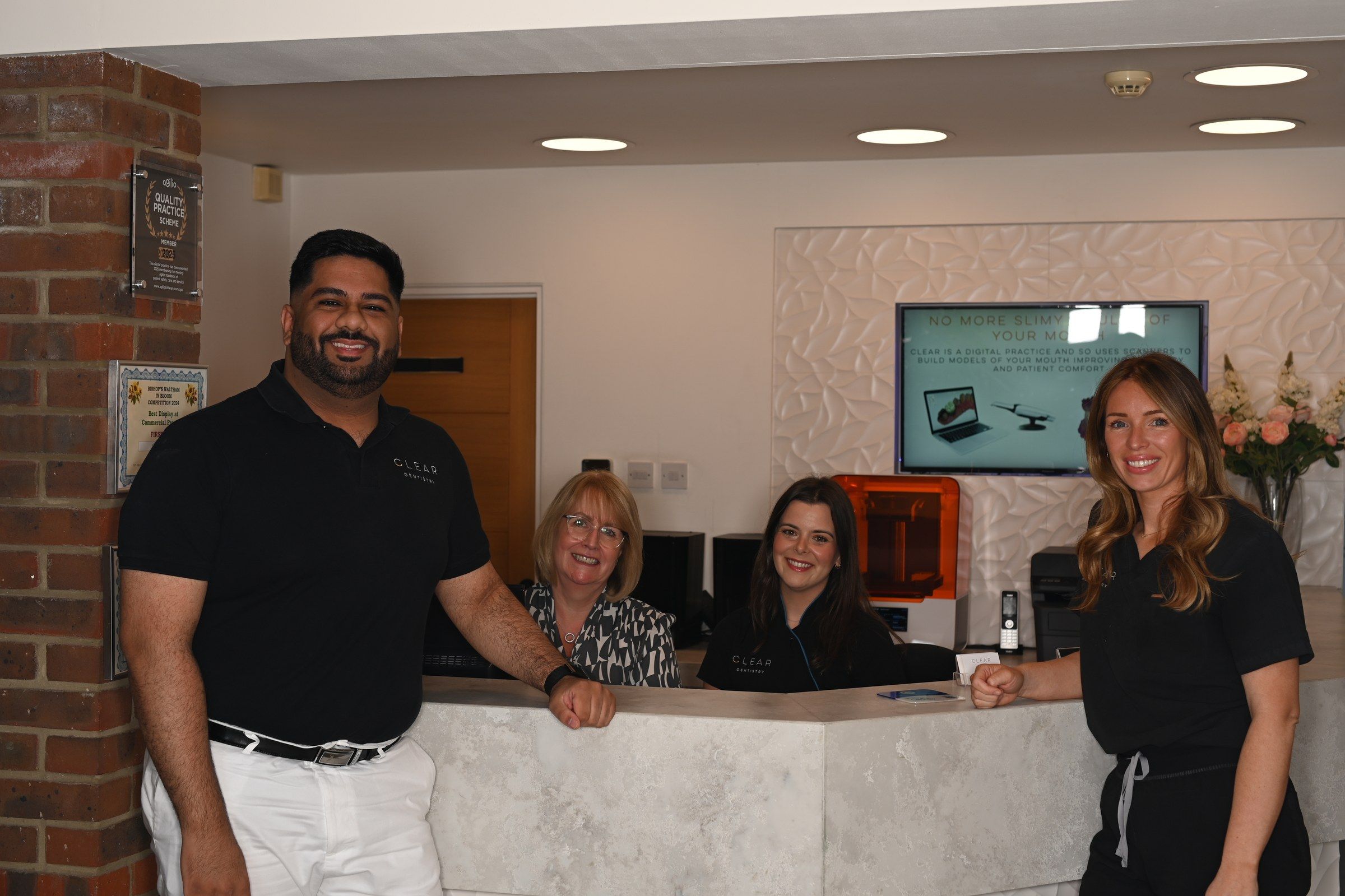 Dr Nirvan Hakiminejad and the reception team welcoming patients at the front desk